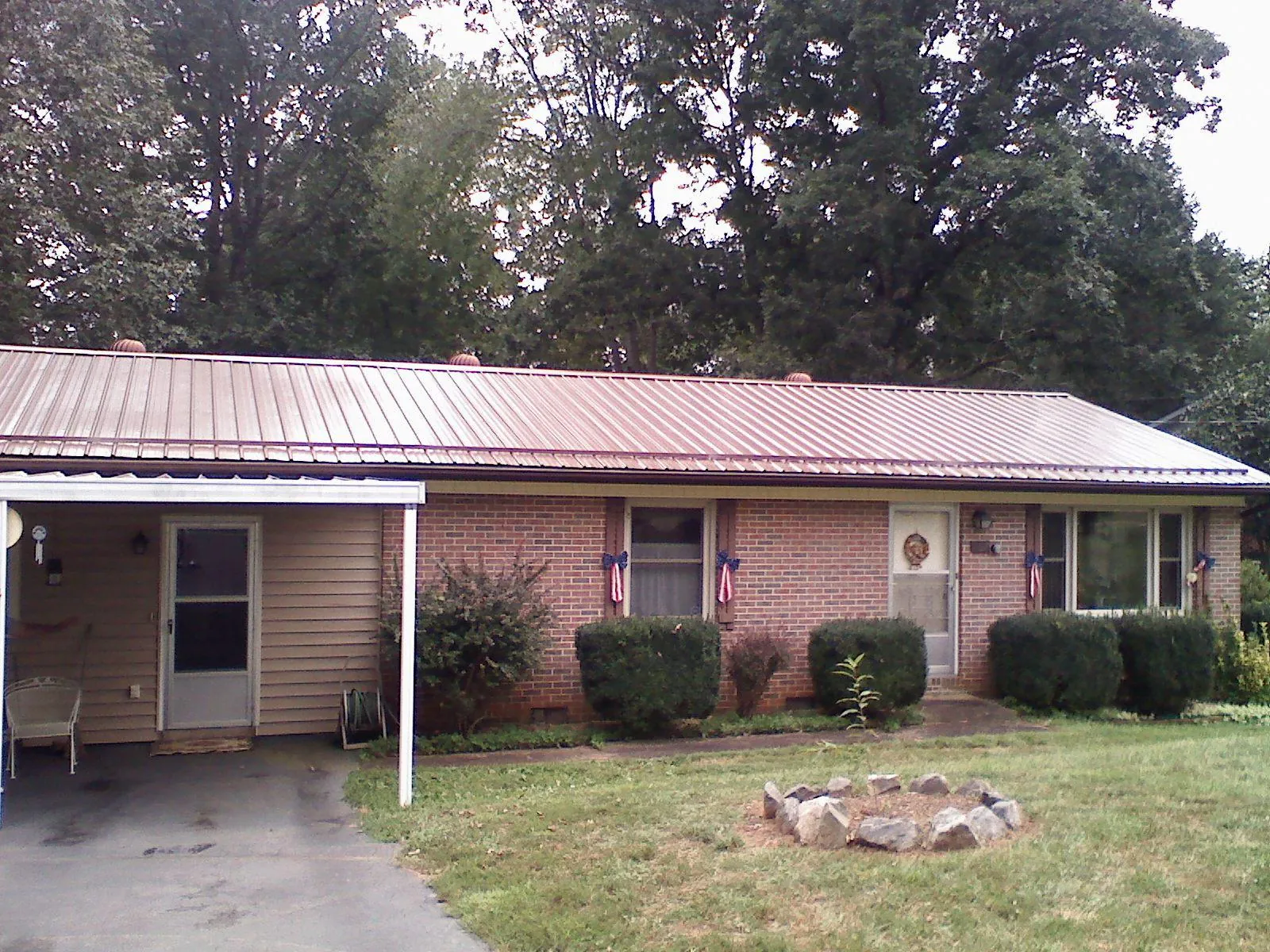 Bronze metal roof and carport on a brick ranch home — Roof Repair work by our crew in Mountville